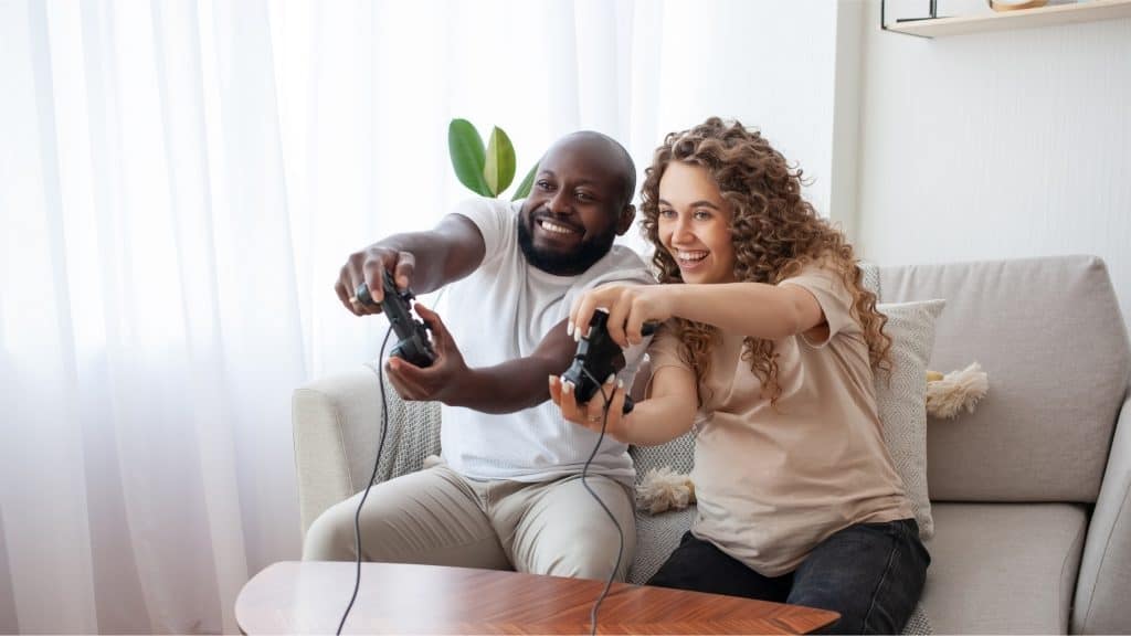 couple playing video games at home 