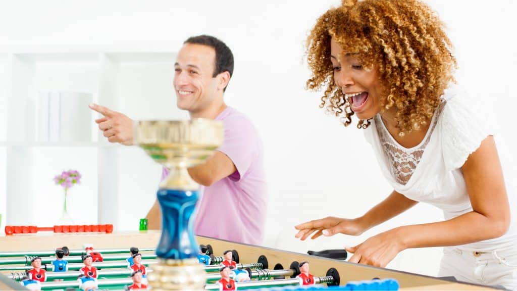 couple playing foosball for date night